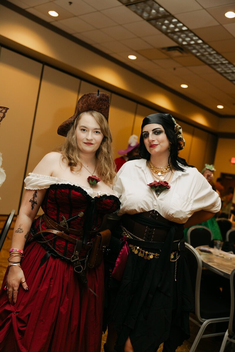 Two guests in pirate-inspired costumes posing together at Phantoms of the Deep