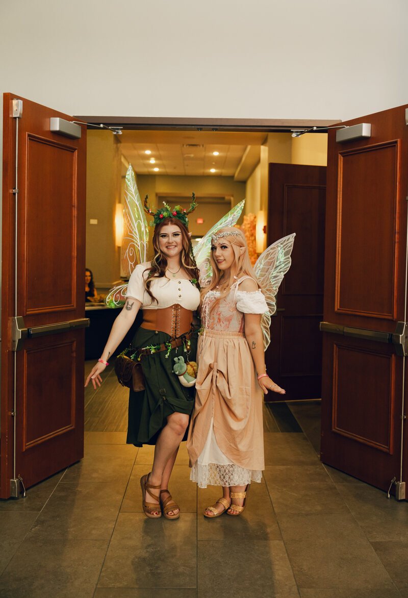 Two guests in fairy costumes posing in an open doorway at Phantoms of the Deep