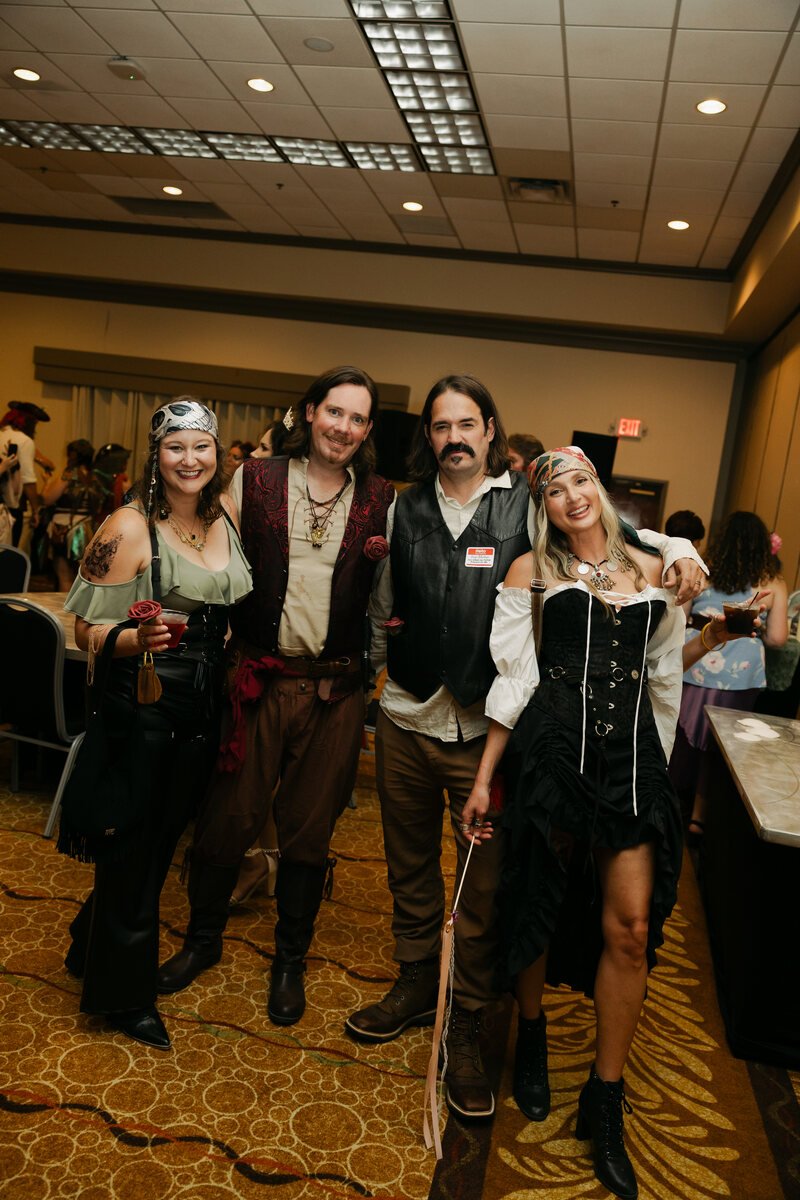 Four pirate-inspired guests posing together at Phantoms of the Deep